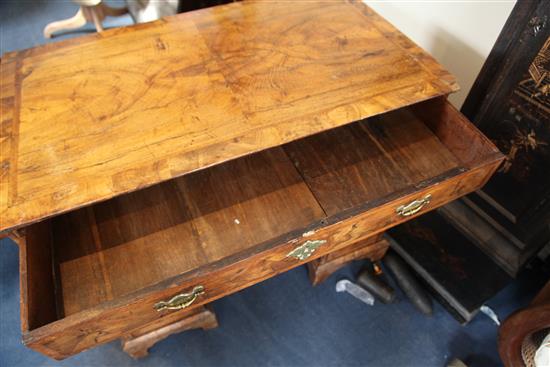 A George II featherbanded walnut kneehole desk, W.3ft 2.5in. D.1ft 10.5in. H.2ft 9in.